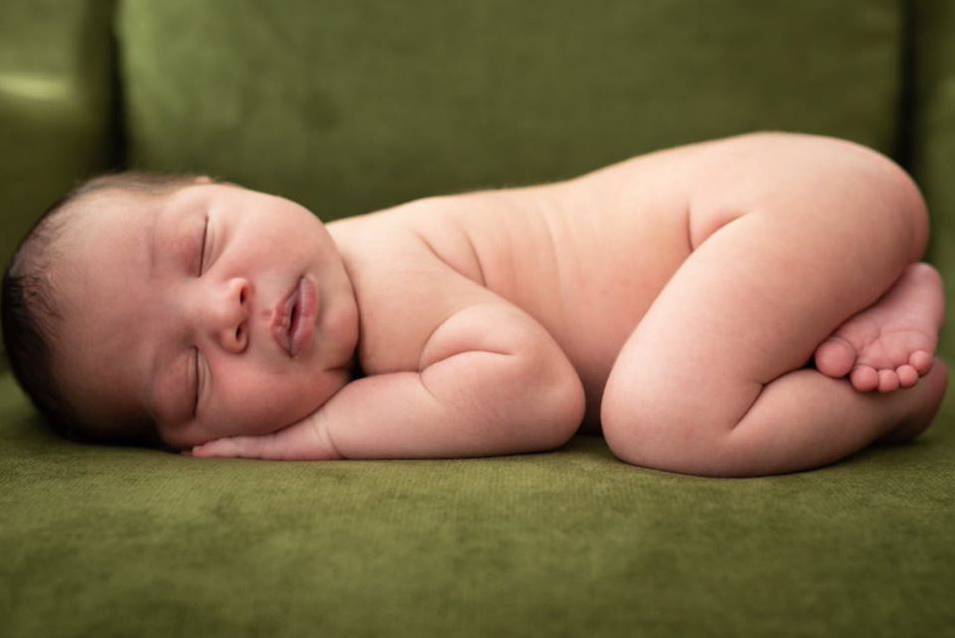 Seattle newborn photographer - professional photo of newborn sleeping on couch